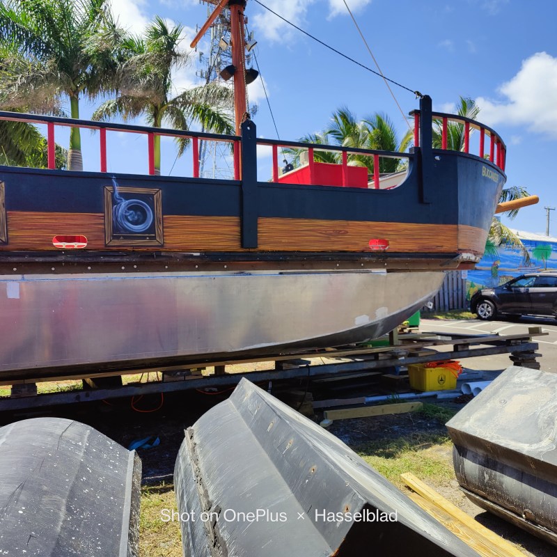 a train is parked on the side of a boat