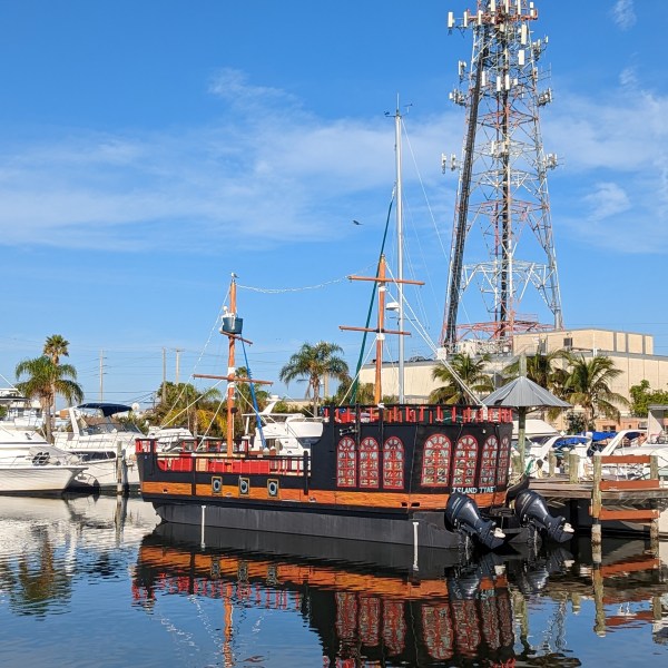a boat is docked next to a body of water