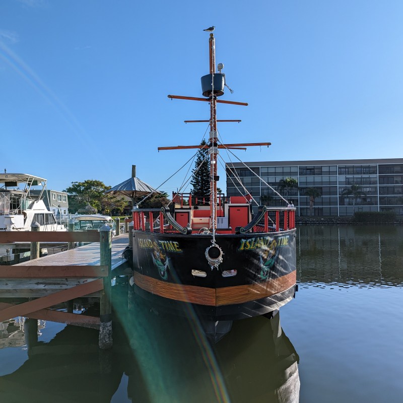 a boat is docked next to a body of water